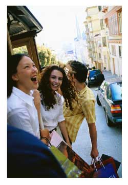 women riding a cable car in san francisco