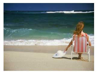 woman relaxing in a chair on a beach vacation