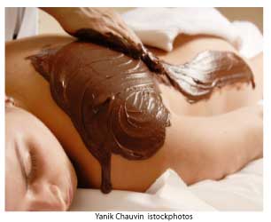 woman receiving chocolate body mask