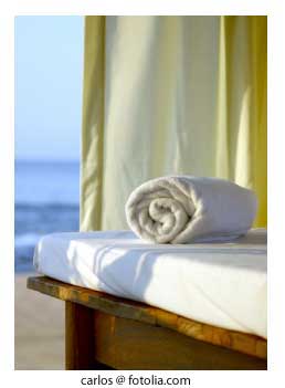 rolled towel on massage table on a caribbean beach