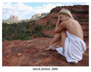woman wrapped in a towel on the red rocks near a Sedona, Arizona spa
