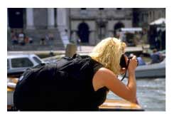 female tourist in Venice, Italy taking a phot