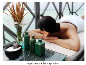 woman relaxing on a massage table overlooking a pool