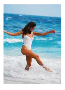 woman playing in the surf of a caribbean beac