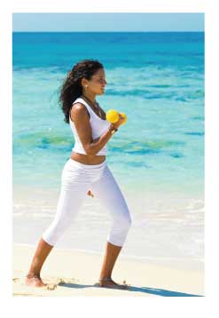 woman on caribbean beach with weights